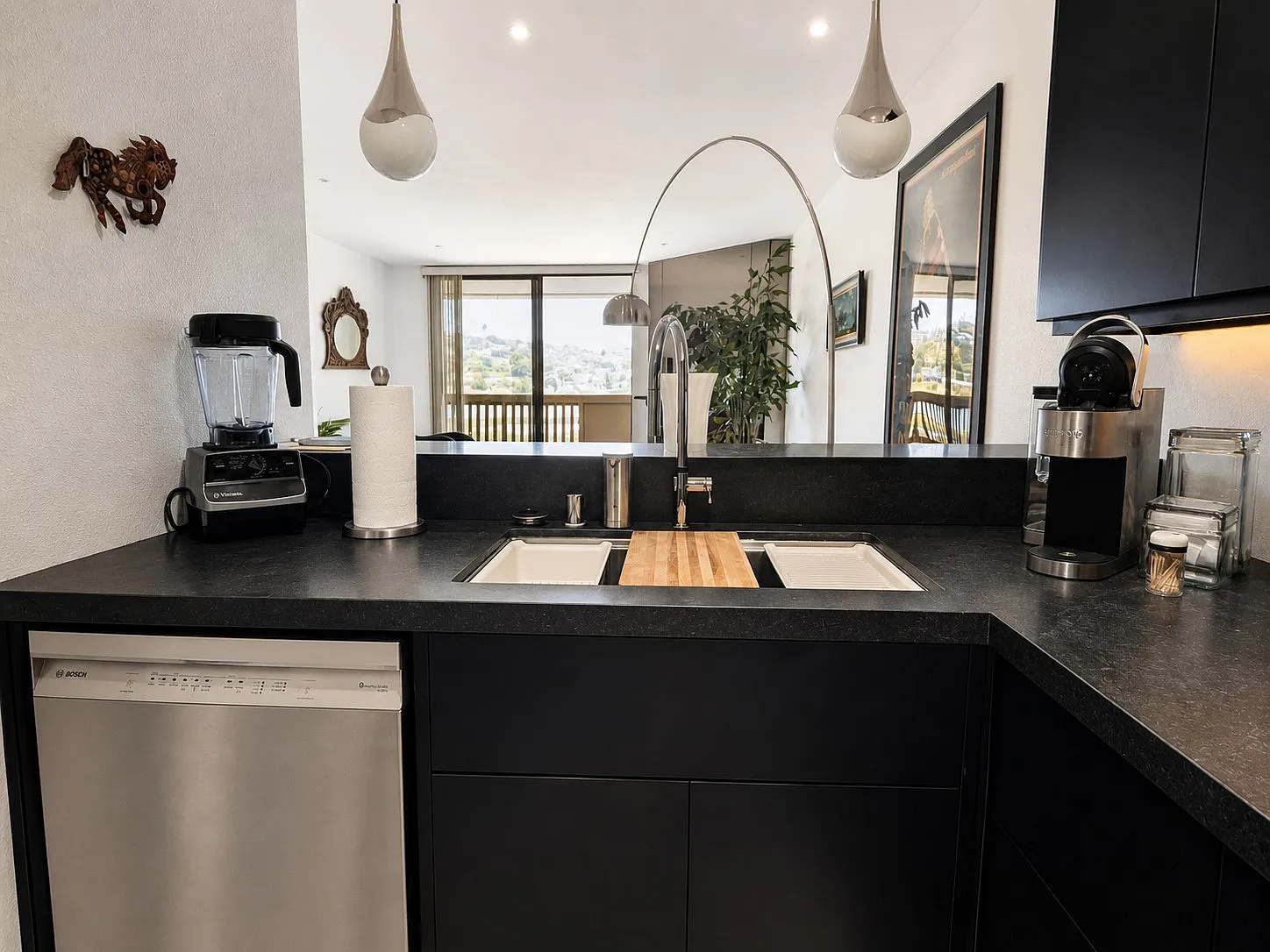 Renovated kitchen with black quartz counters and view, Point Loma condo